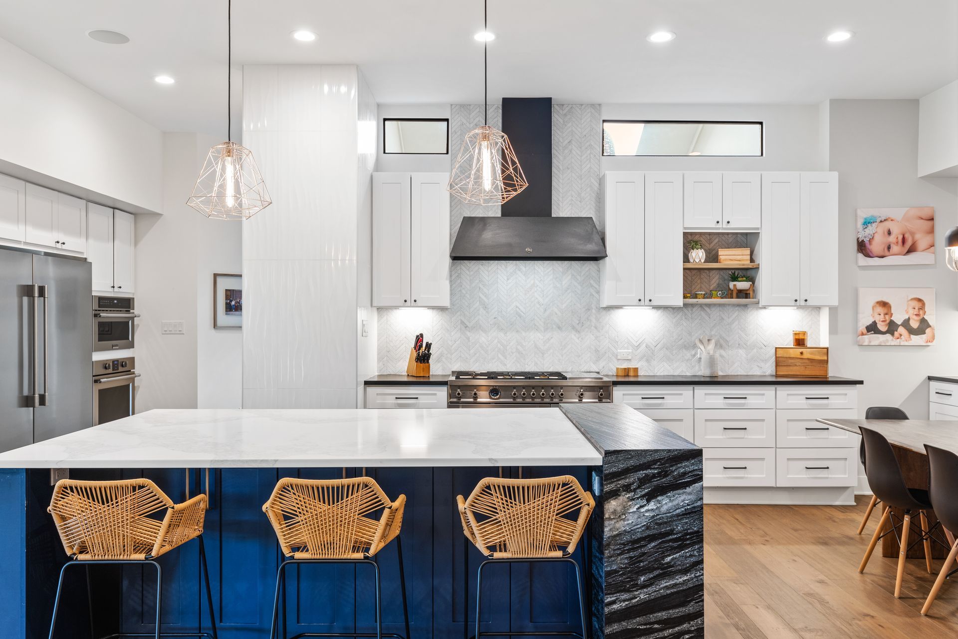 A kitchen with a blue island and white cabinets