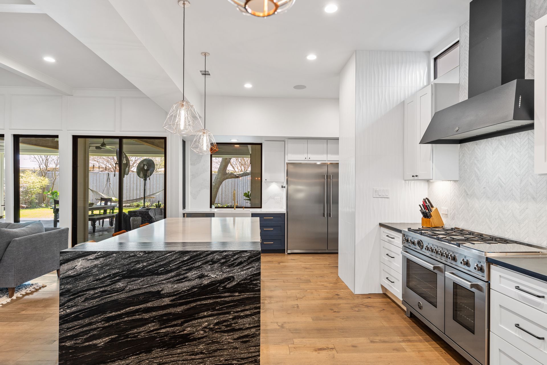 A kitchen with stainless steel appliances and granite counter tops.