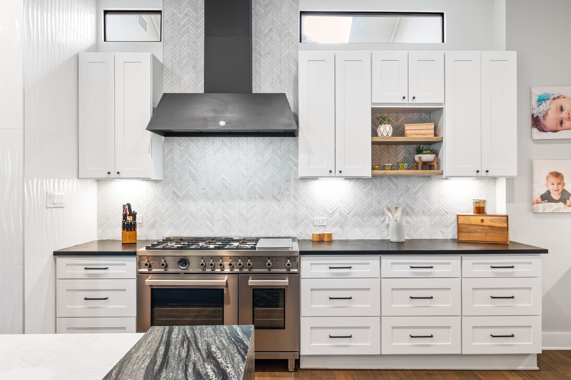 A kitchen with white cabinets and stainless steel appliances.