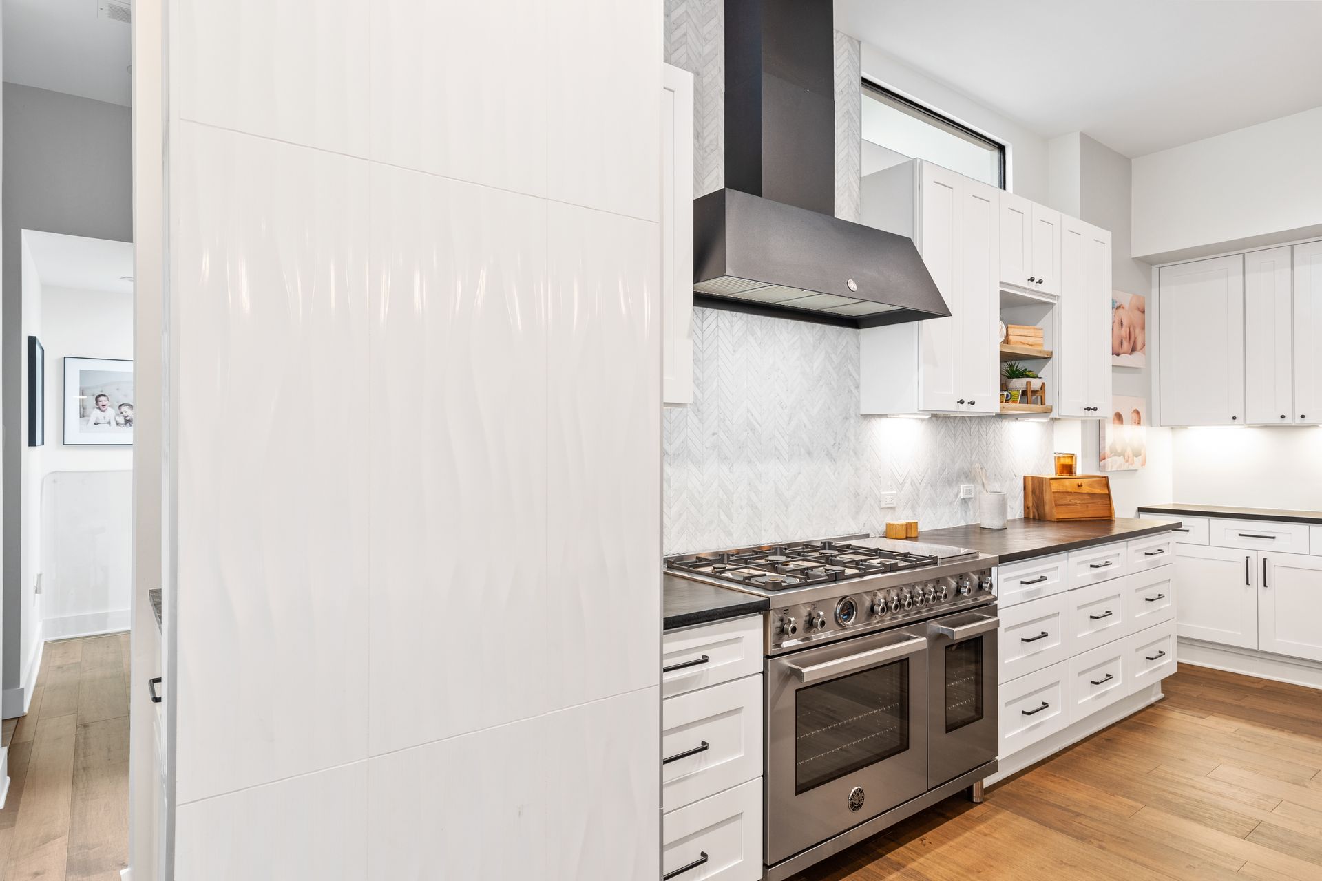 A kitchen with white cabinets and stainless steel appliances.