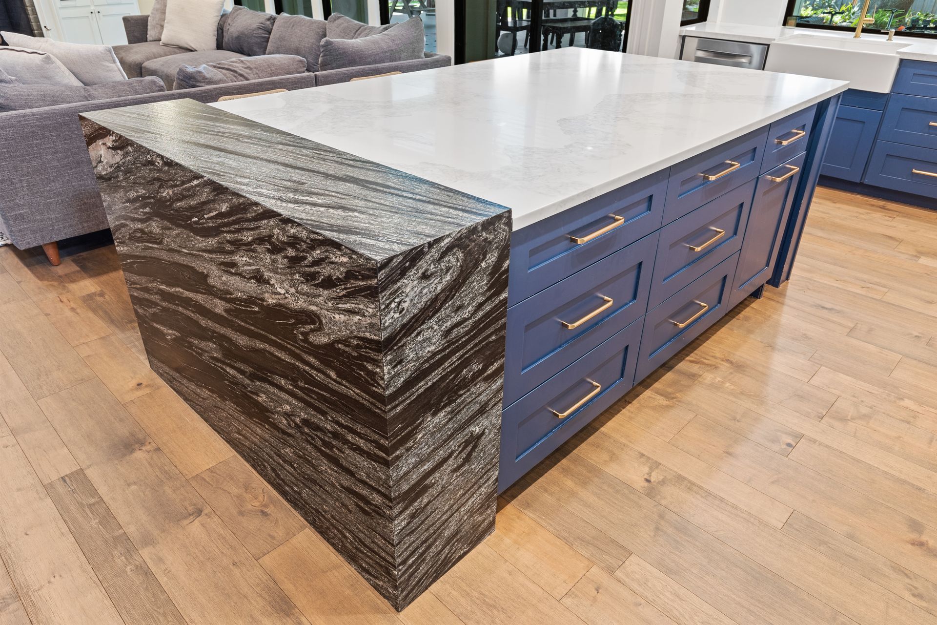 There is a large island in the middle of the kitchen.