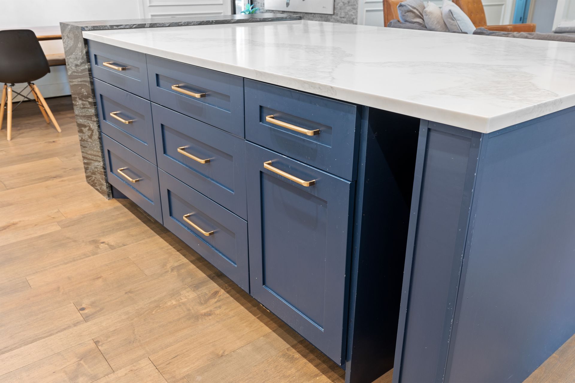 A kitchen with blue cabinets and a white counter top.