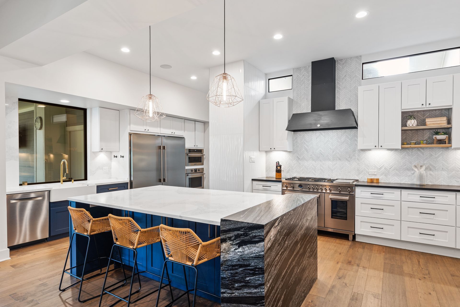 A large kitchen with a large island and stools.