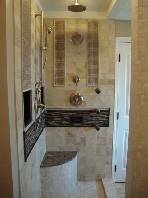 A bathroom with a walk in shower and a bench