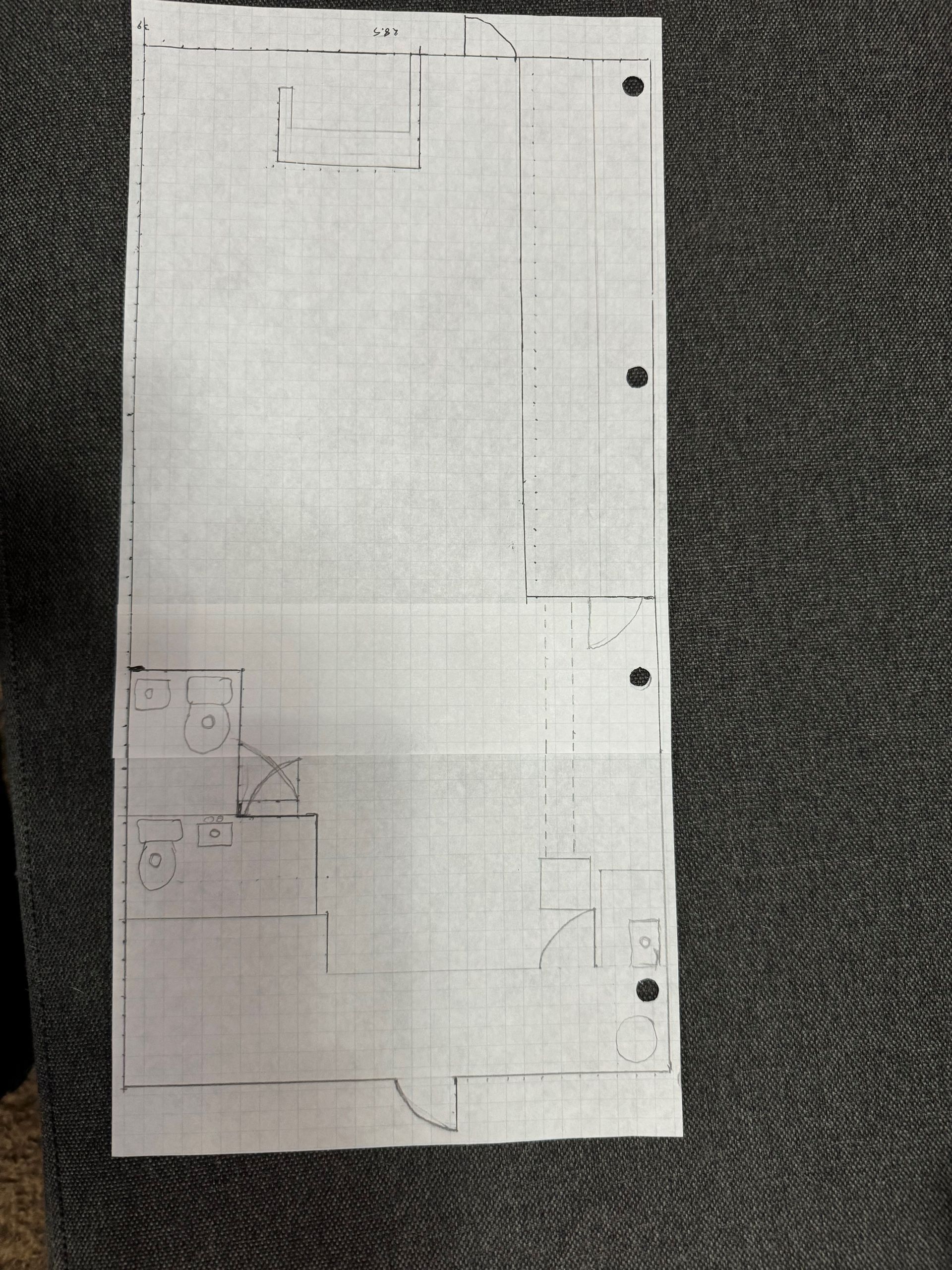 Hand-drawn floor plan on grid paper, showing rooms, kitchen, and door openings.