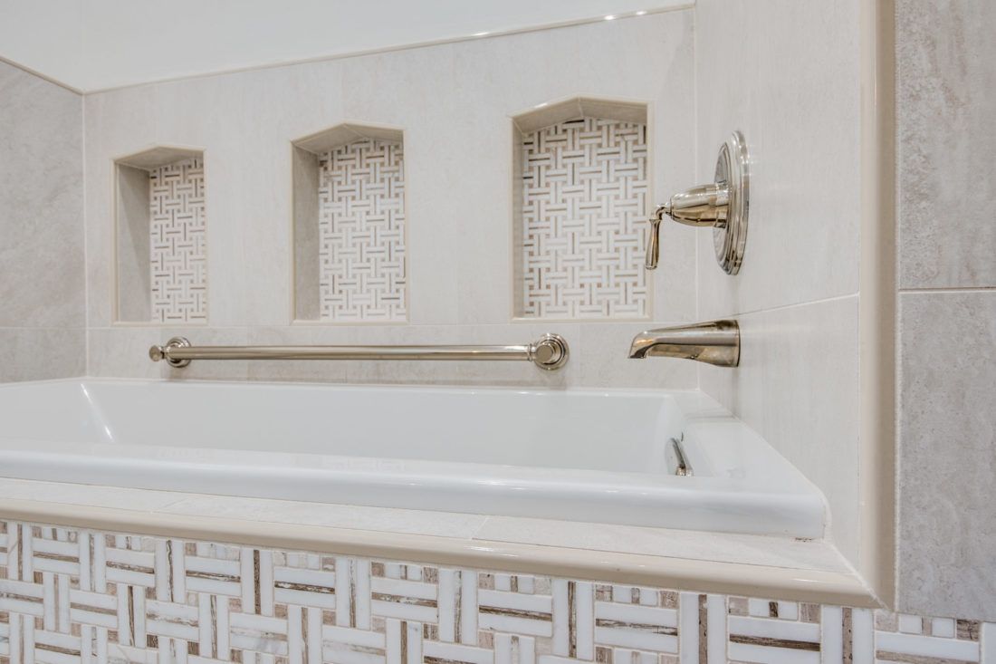 A bathroom with a bathtub and a shower.