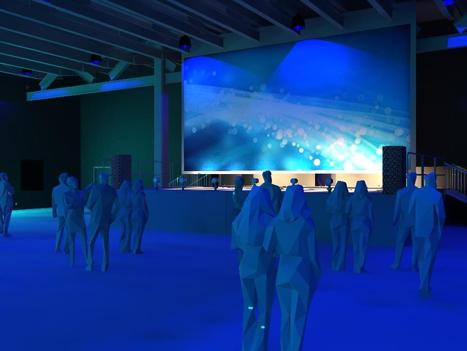 A group of people are standing in front of a large screen.