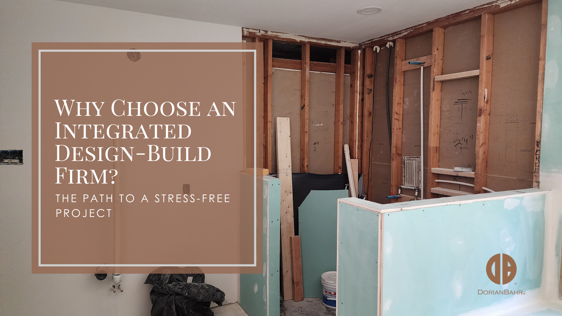 A room under construction, drywall removed revealing wood framing. Text overlay: 