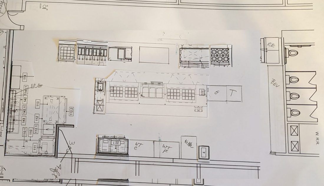 A black and white drawing of a building on a white surface.