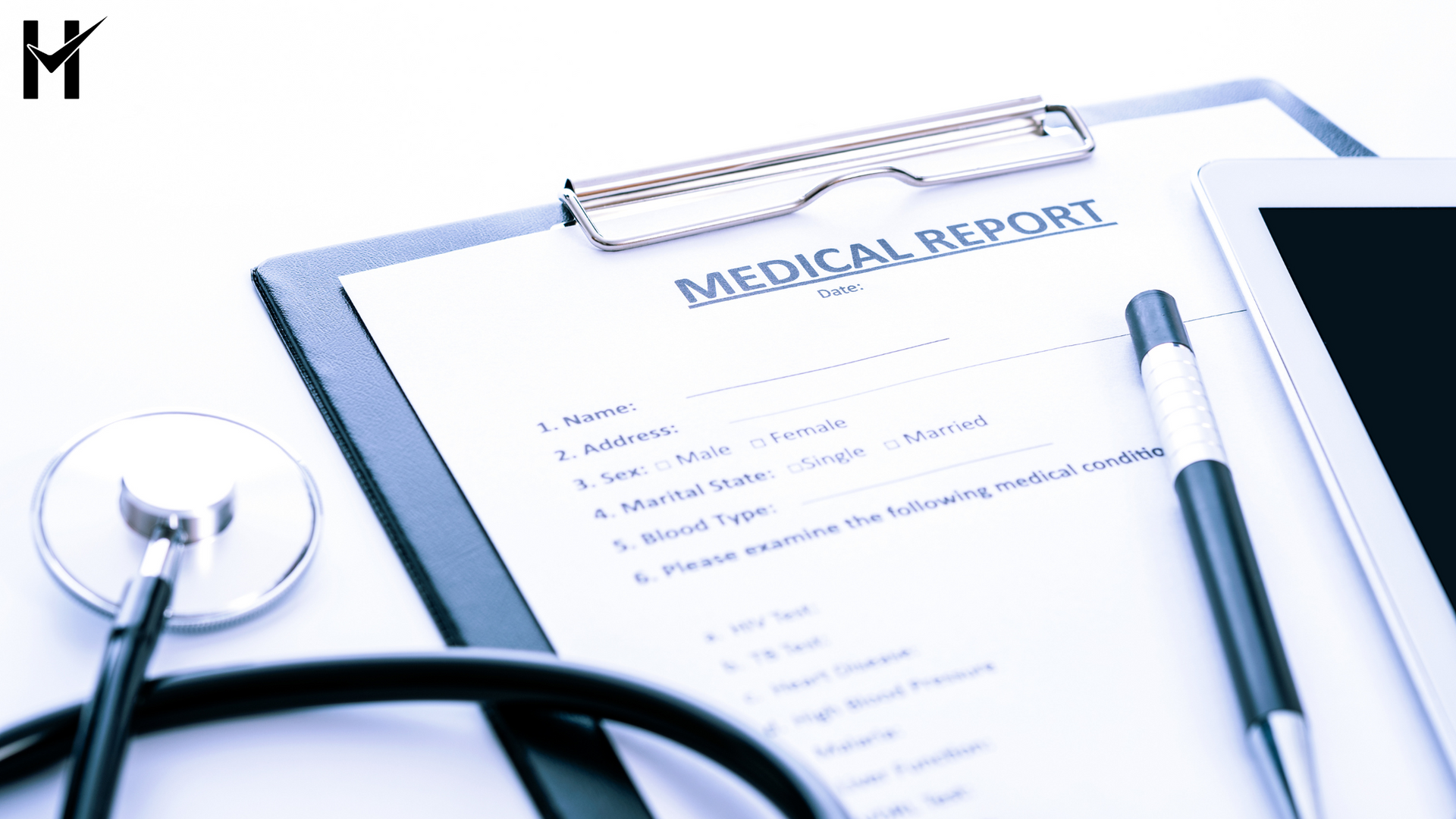 Medical report on a clipboard with a stethoscope and tablet.