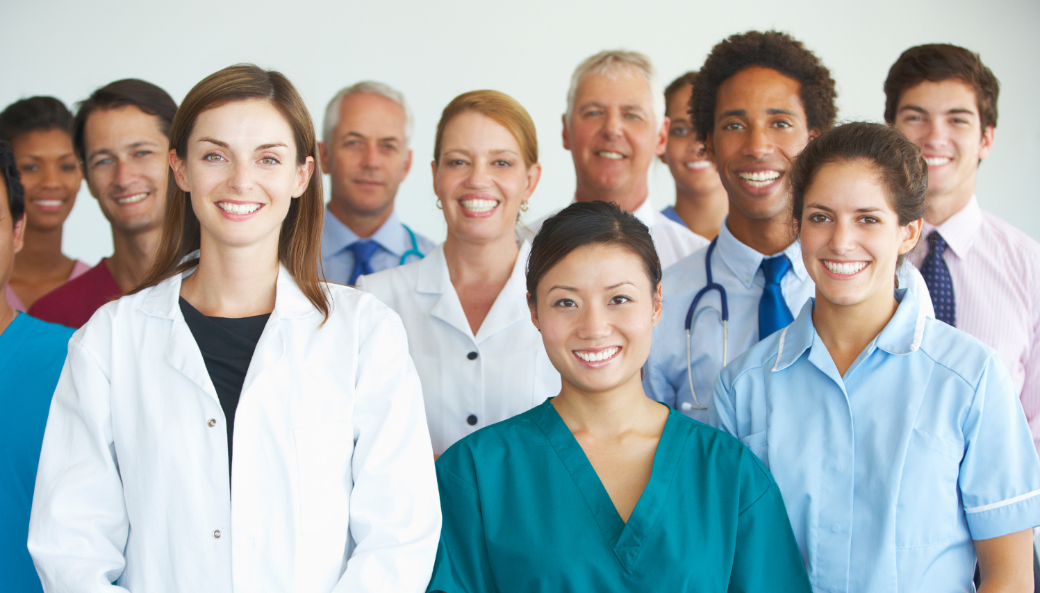 Group of diverse healthcare professionals smiling at the camera.