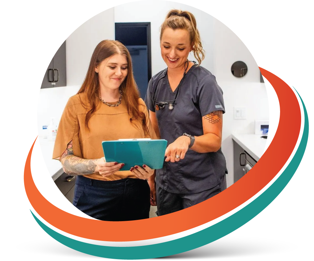 Woman and healthcare provider reviewing a chart in a medical office.