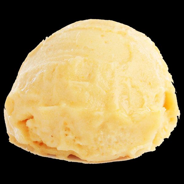 A scoop of pale yellow ice cream on a black background