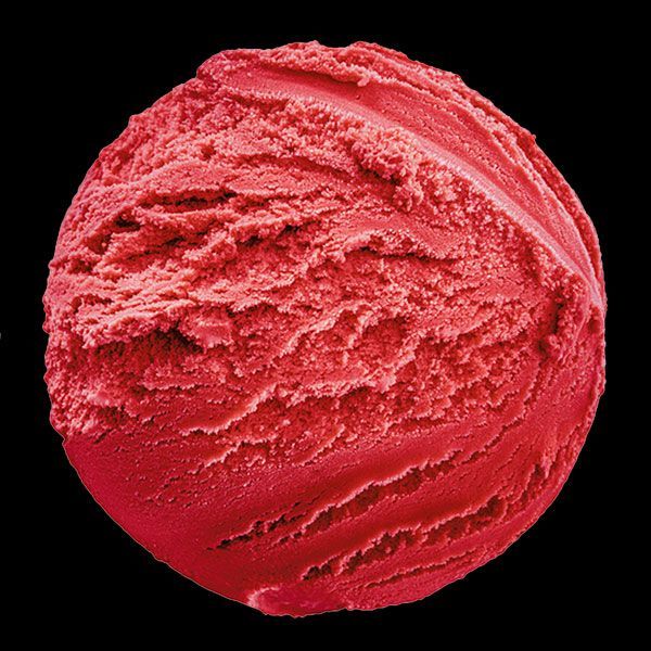 Red scoop of berry sorbet on a black background