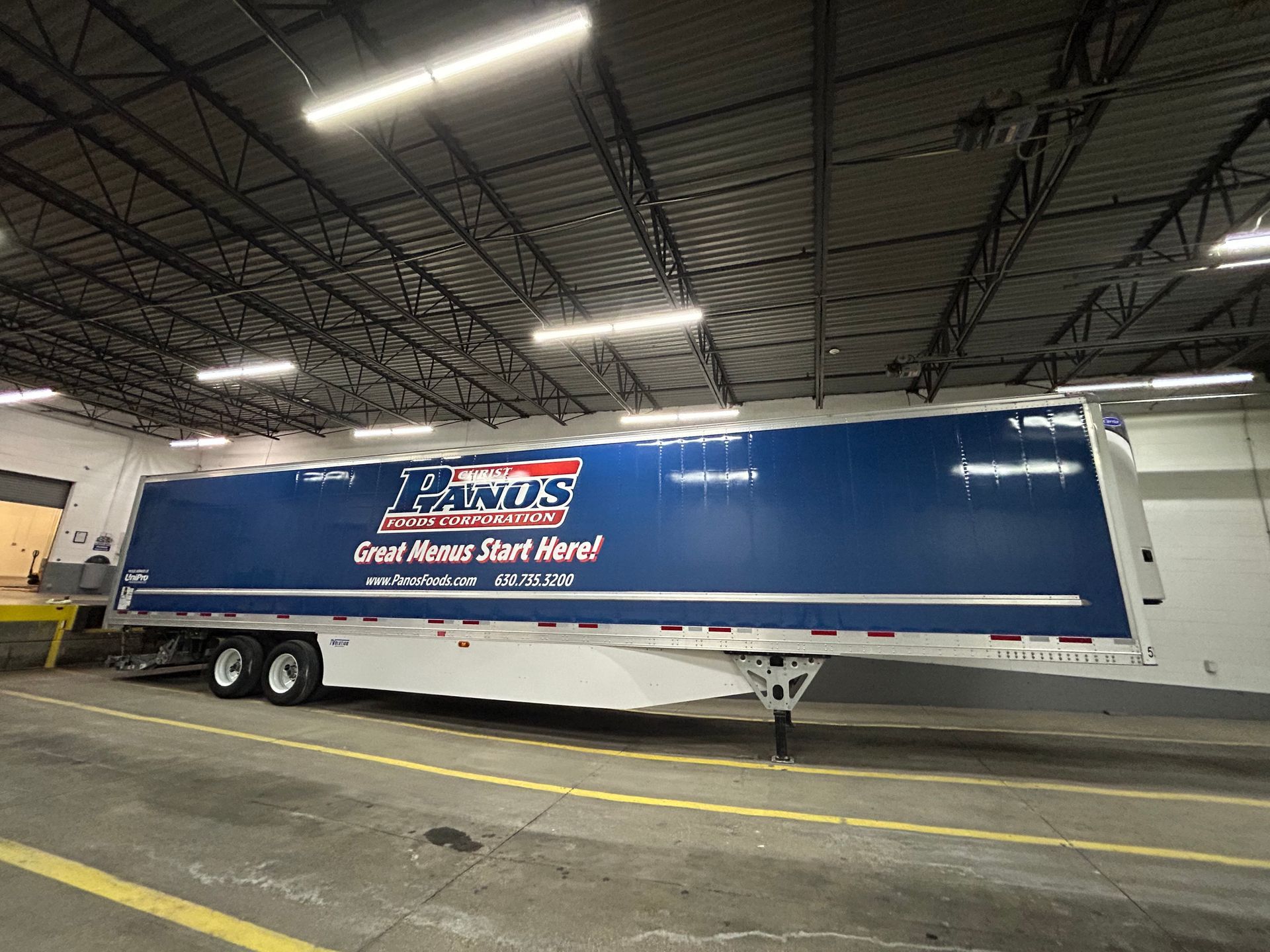 A blue and white commercial semi-trailer with the 