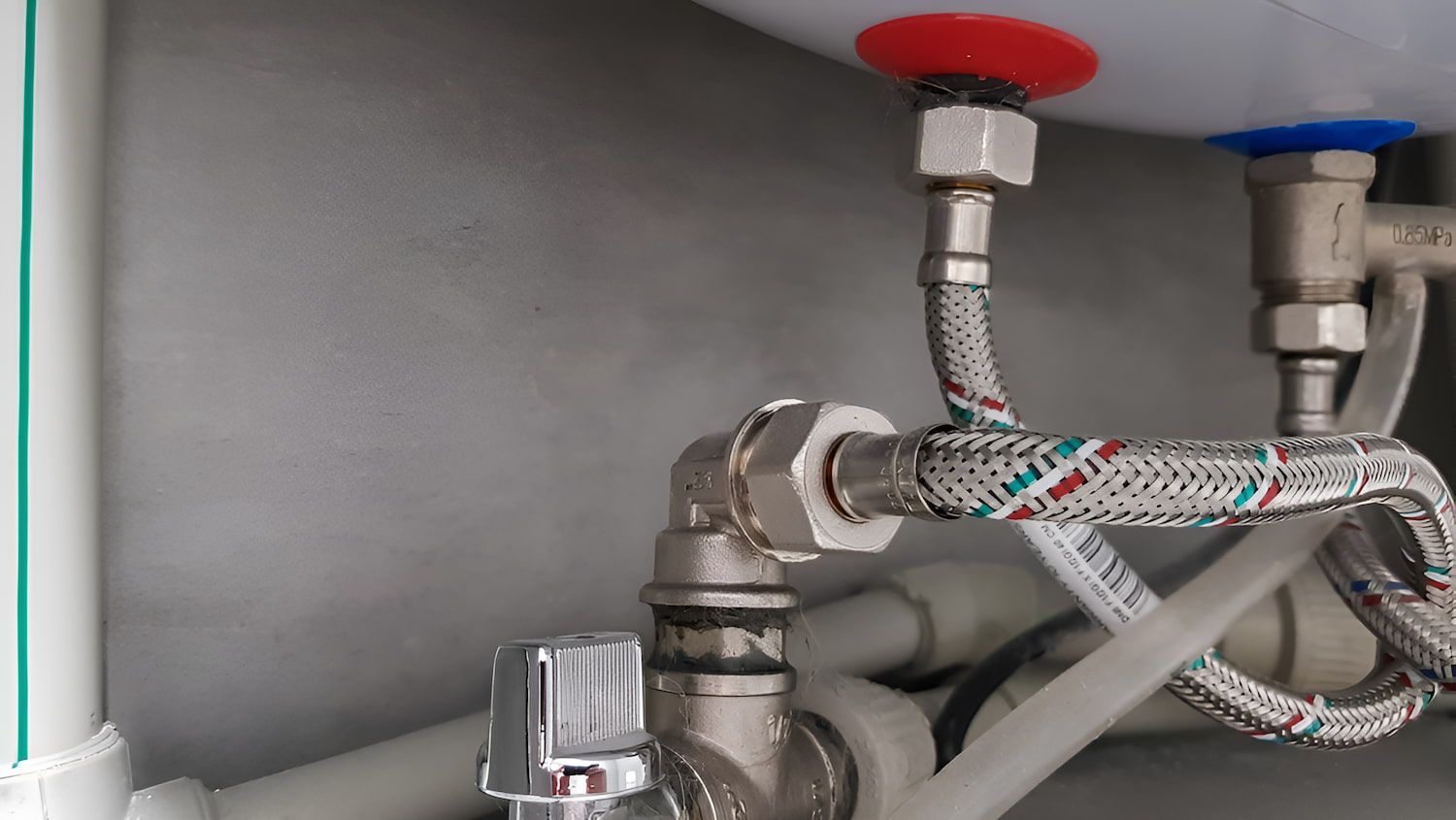 A Close Up Of A Water Heater With A Hose Attached To It — Ashley Chick Plumbing In Wodonga, VIC