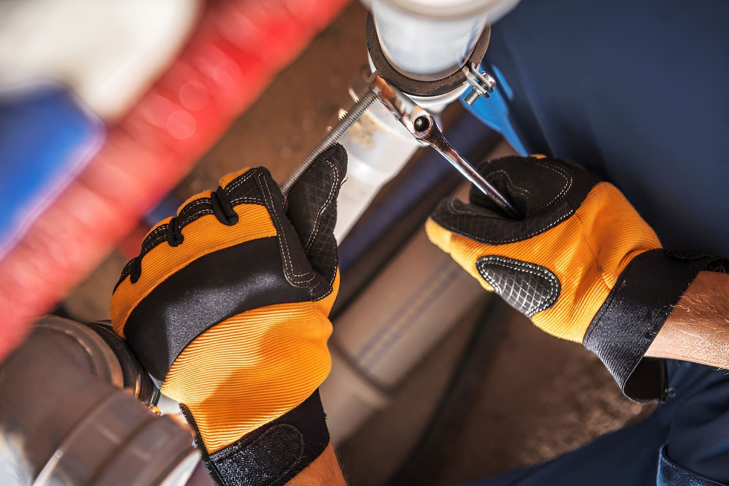 A Plumber Is Fixing A Sink Pipe With A Wrench — Ashley Chick Plumbing In Beechworth, VIC