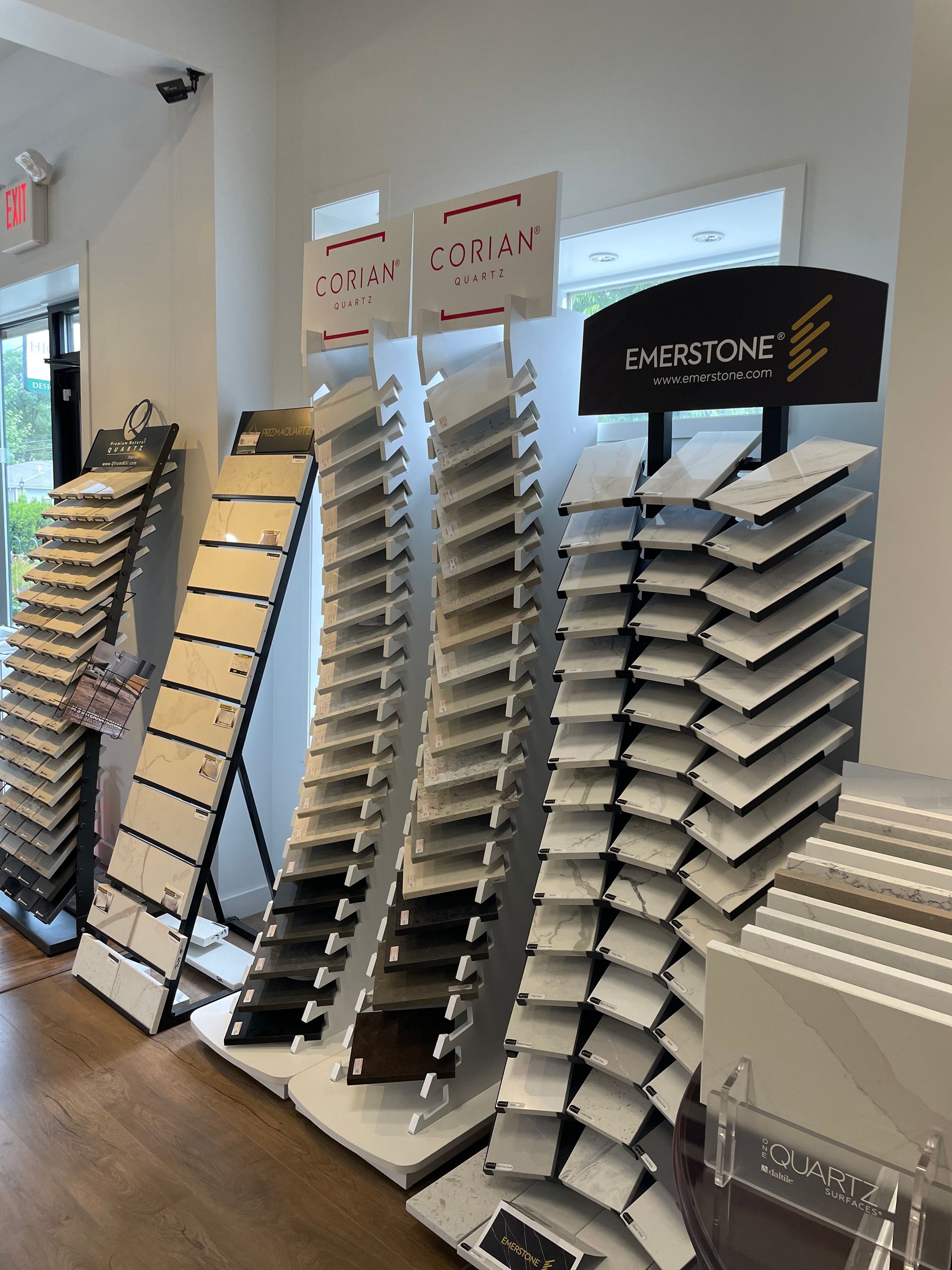 Brochure display racks in a bright lobby with black and white signage and stacked pamphlets
