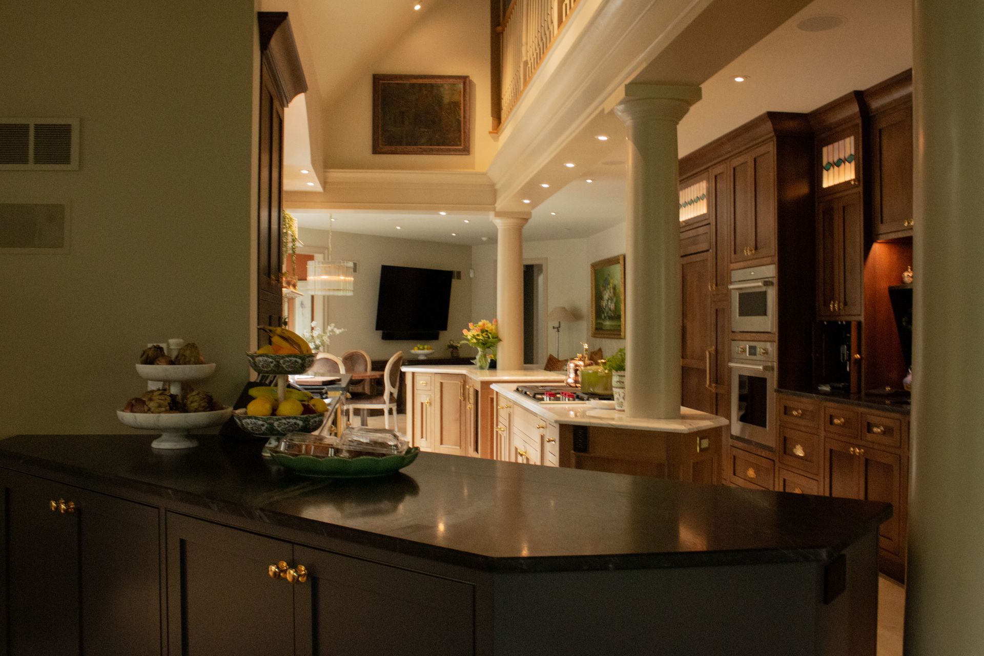 Elegant kitchen with granite island, pendant lights, and built-in wooden cabinets