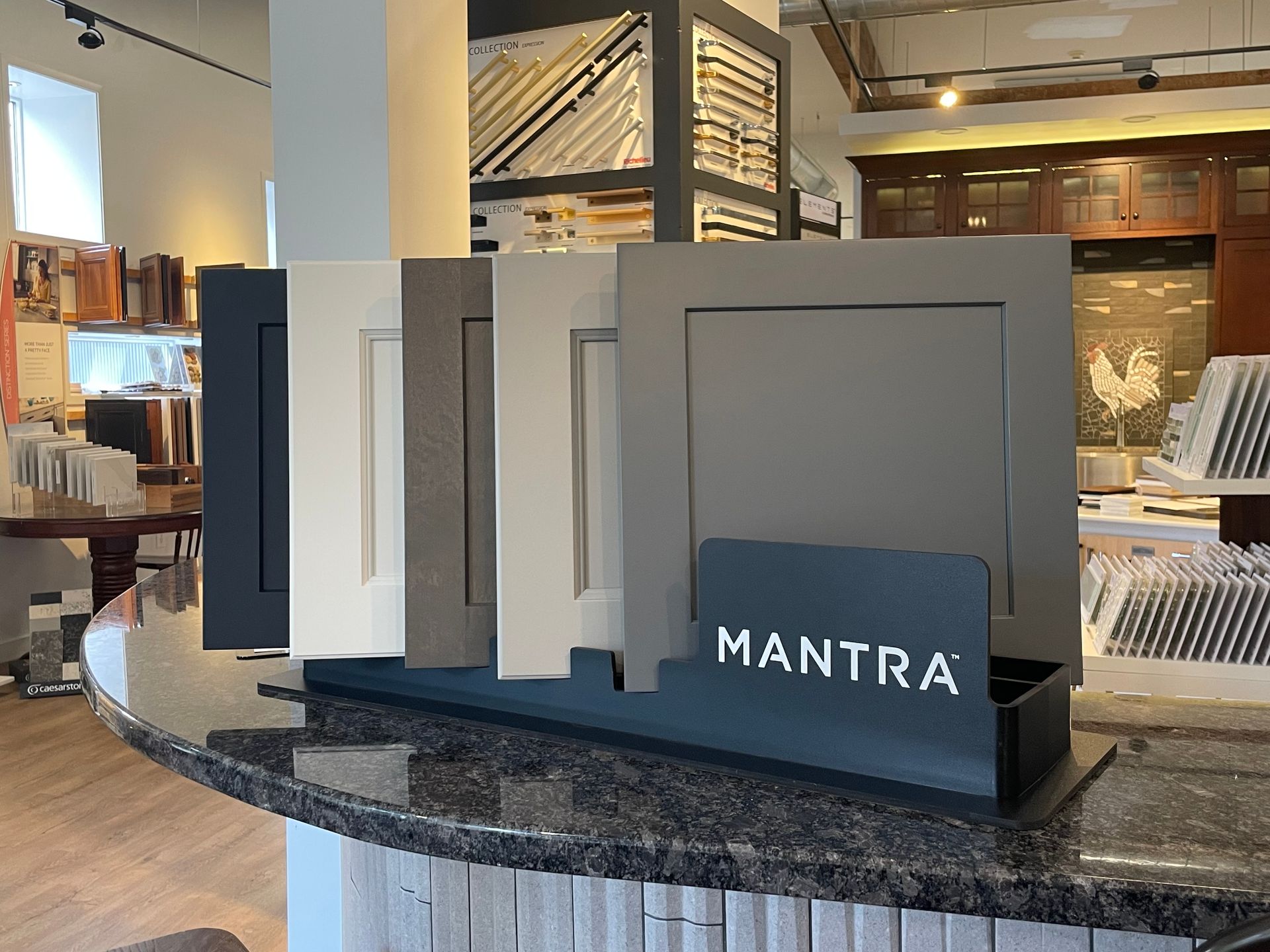 MANTRA signage on a countertop display in a retail interior with shelves and warm lighting
