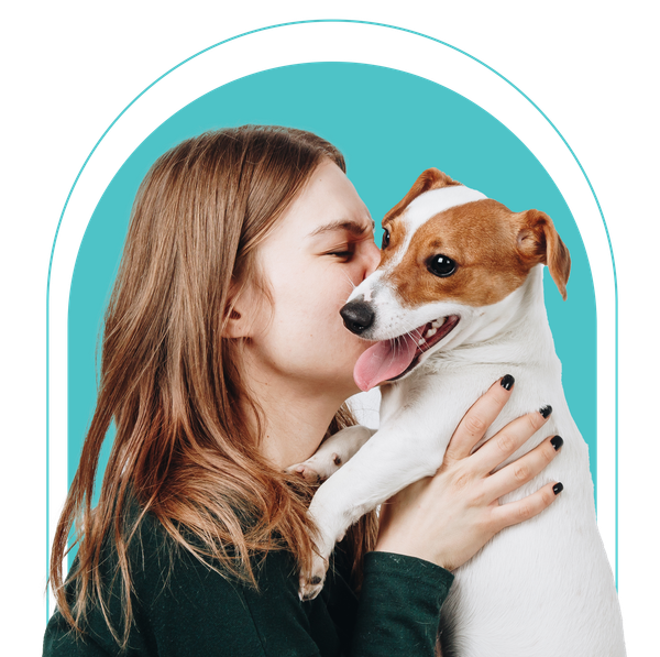 A woman is kissing a brown and white dog on the nose.