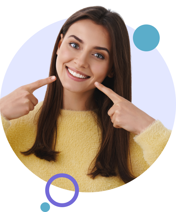Woman smiling and pointing to her teeth