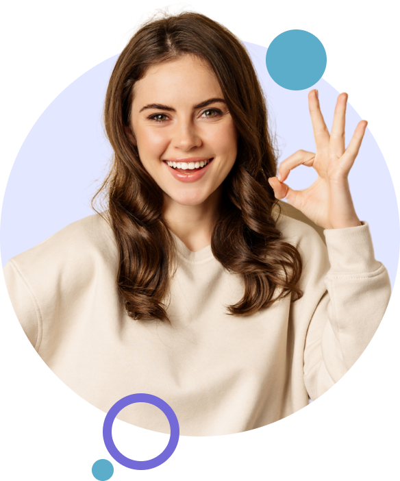 A woman smiling and making he okay sign with her hand