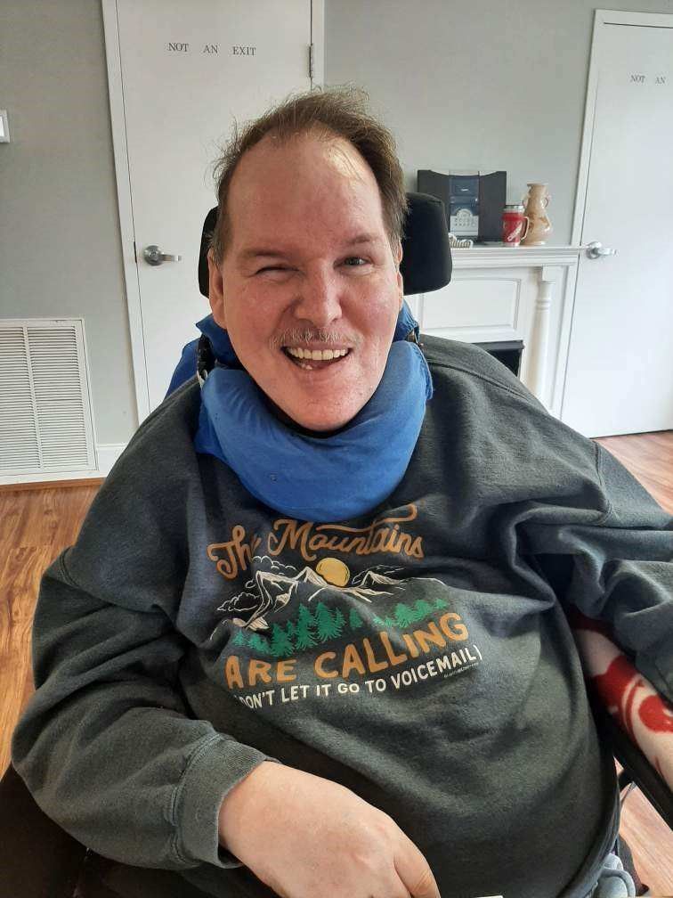 Up close image of a safehaven resident smiling at the camera