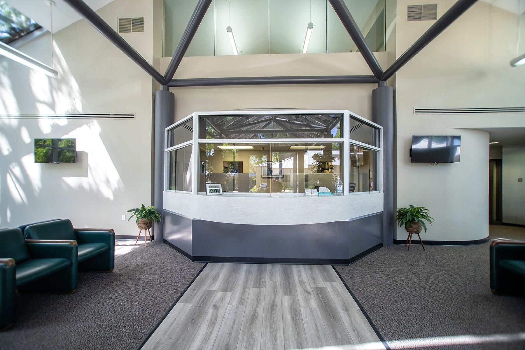 A lobby with a large window and a reception desk