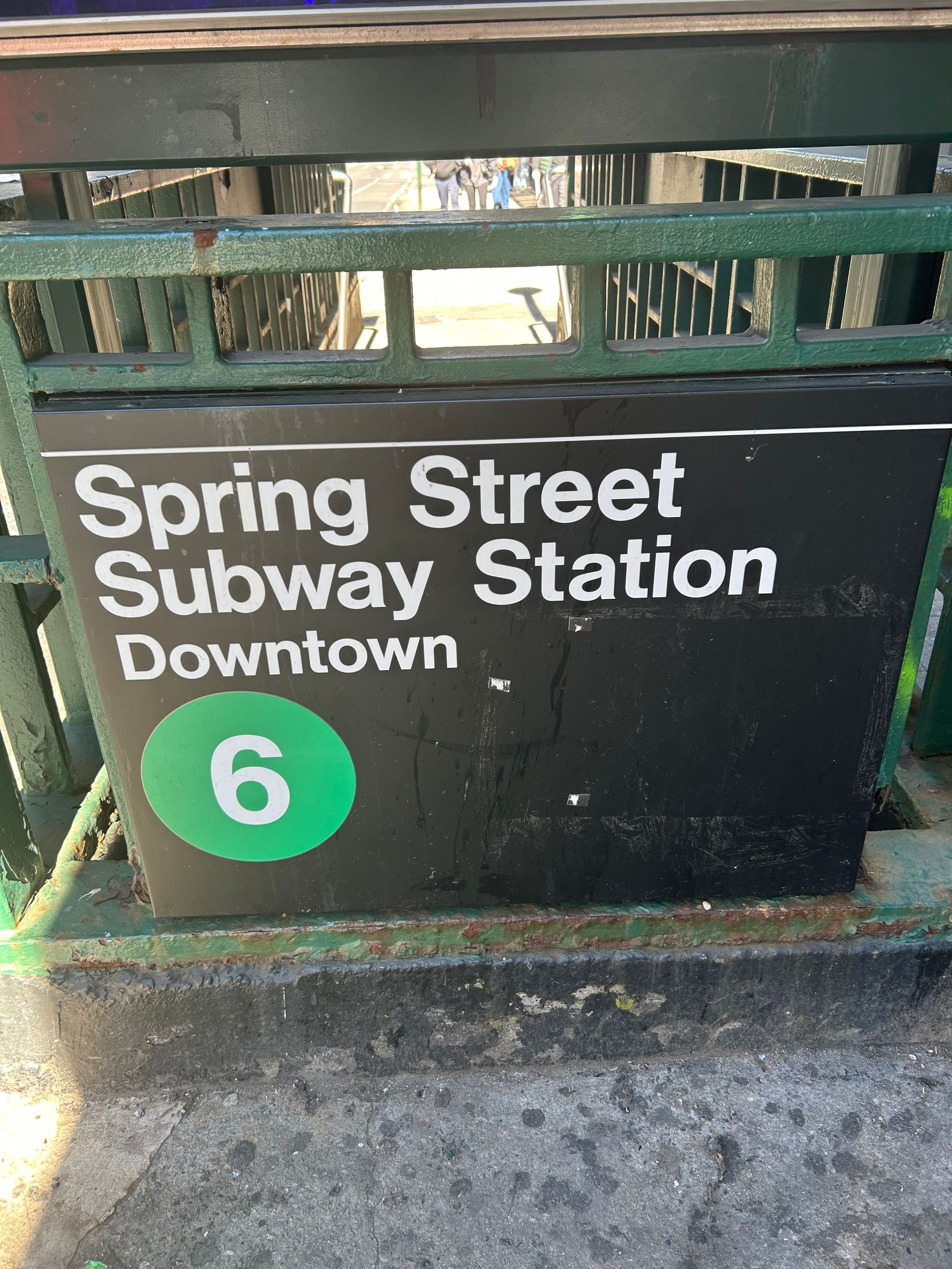 Spring Street Subway Station sign with green 6 line marker, downtown