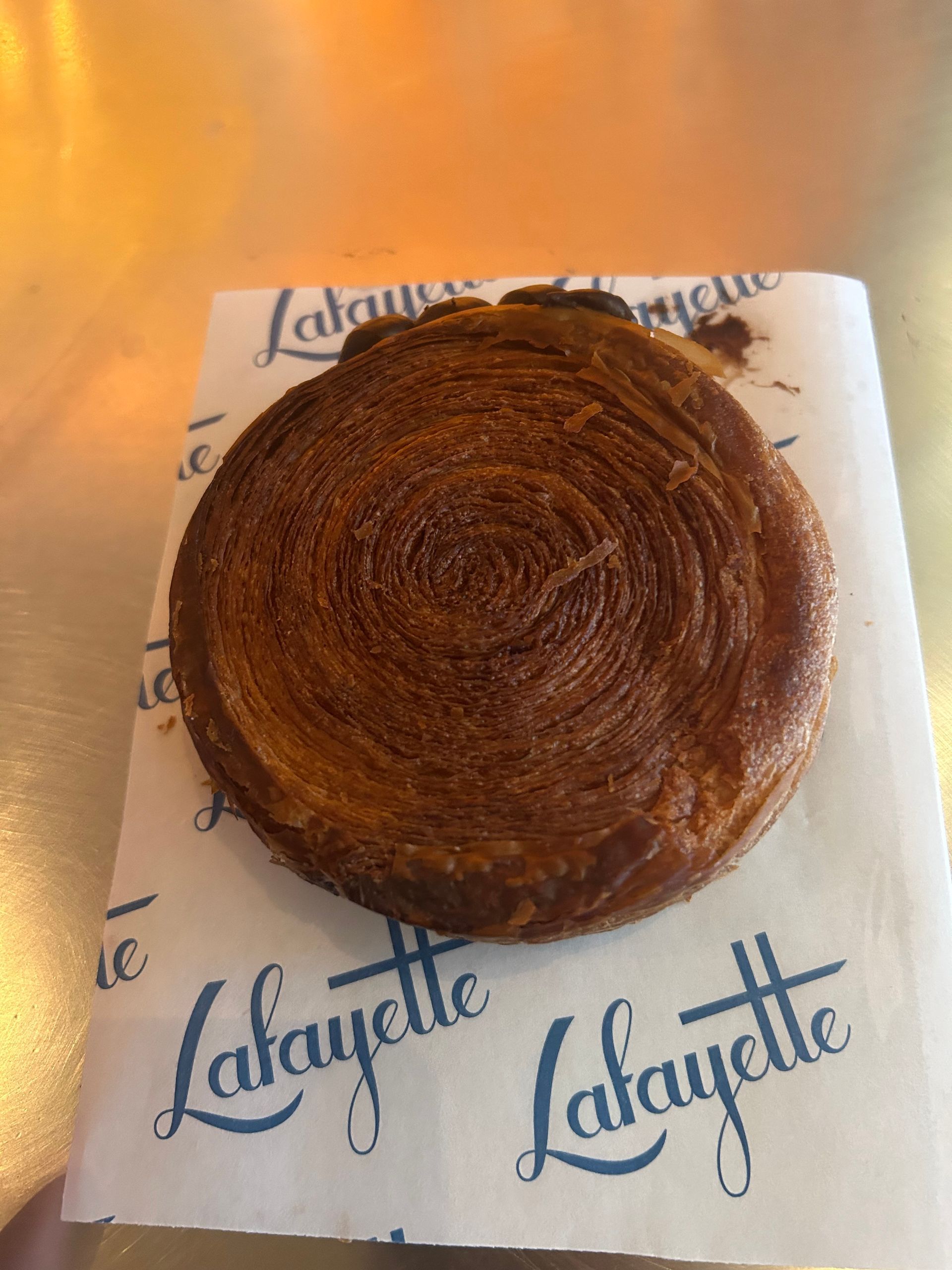 Dark brown spiral pastry on a Lafayette napkin on a table