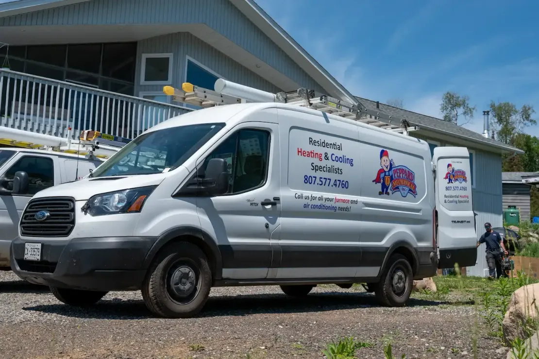 Silver delivery van parked outside a building, with a colorful logo on the side.