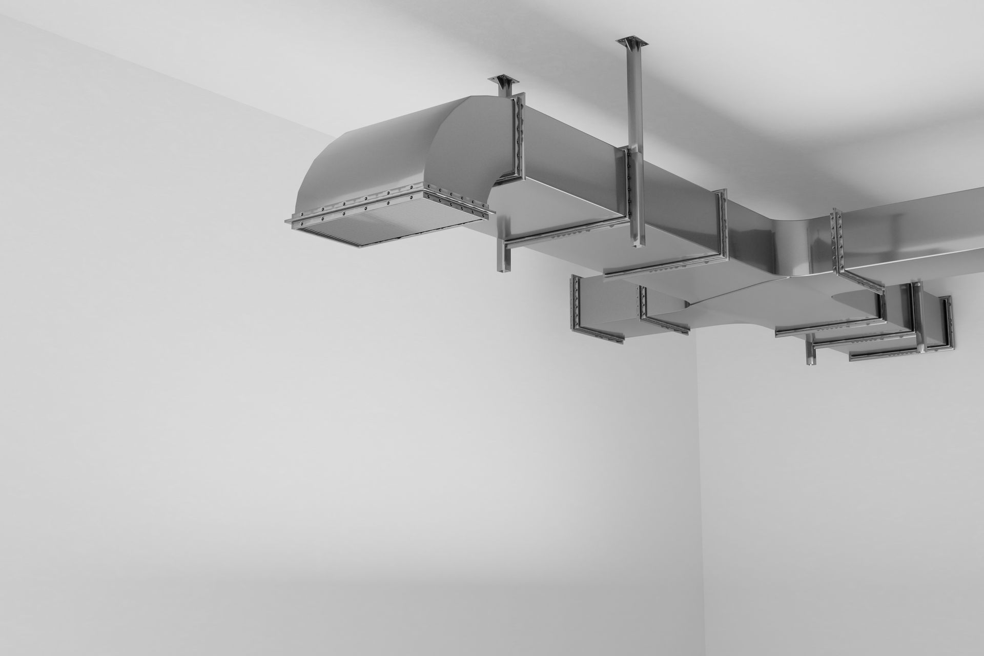 Ceiling-mounted metal track with brackets and rails in a white room