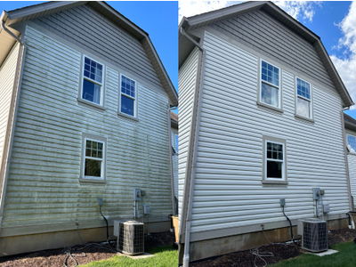 Before-and-after view of a house exterior, showing siding cleaned from dirty to bright white.