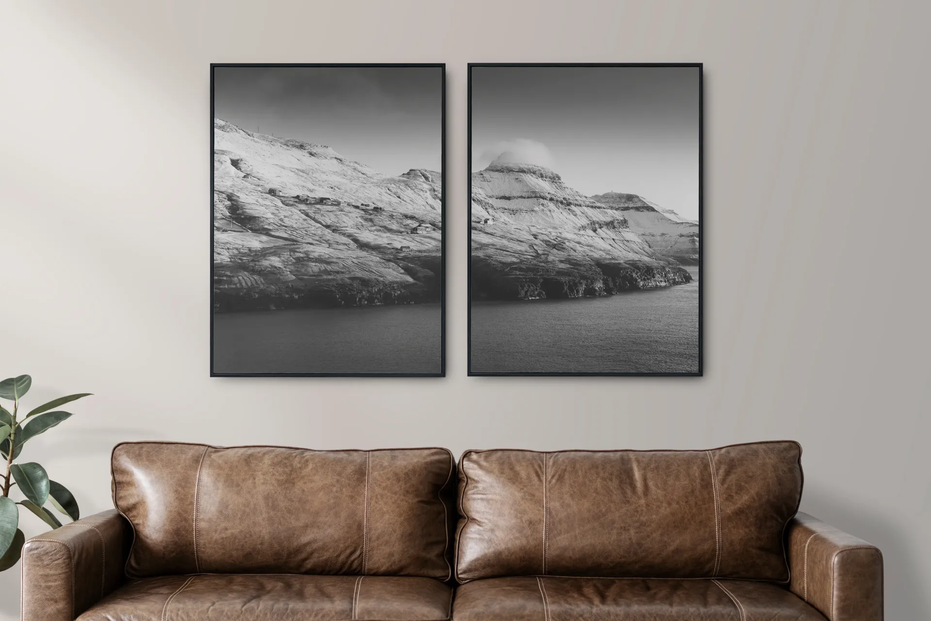 Living room with brown sofa beneath two framed black-and-white mountain prints