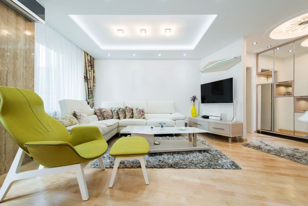 Living Room With A Couch Chair Table And Television — Pro Vision Property Inspections In Merewether, NSW