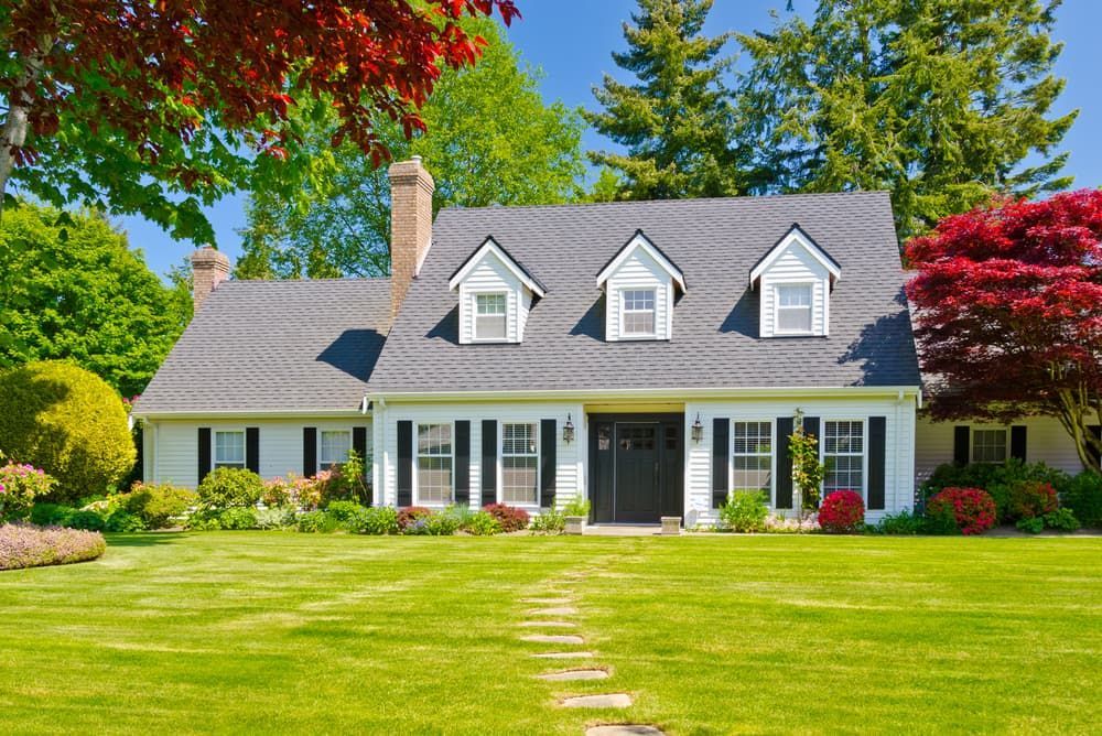 Large White House With A Lush Green Lawn In Front Of It — Pro Vision Property Inspections In Lake Macquarie, NSW