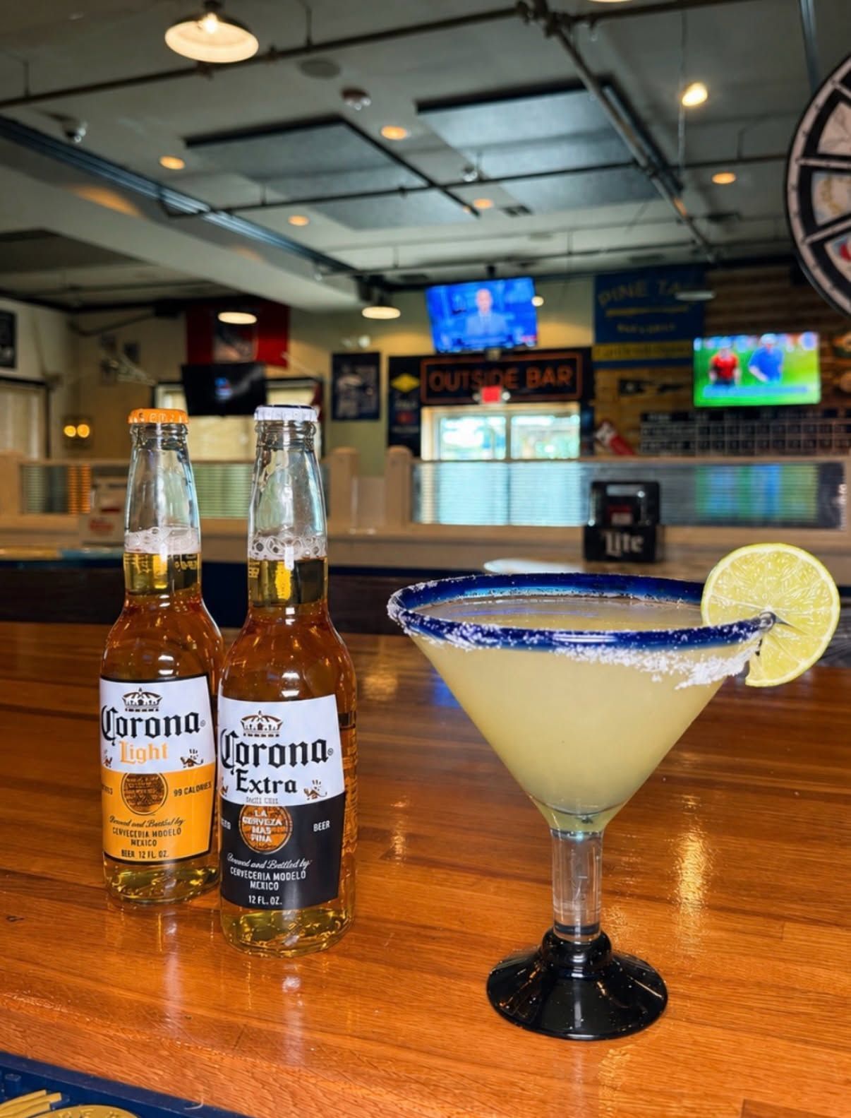 Corona beers and a margarita on a bar counter in a casual restaurant setting