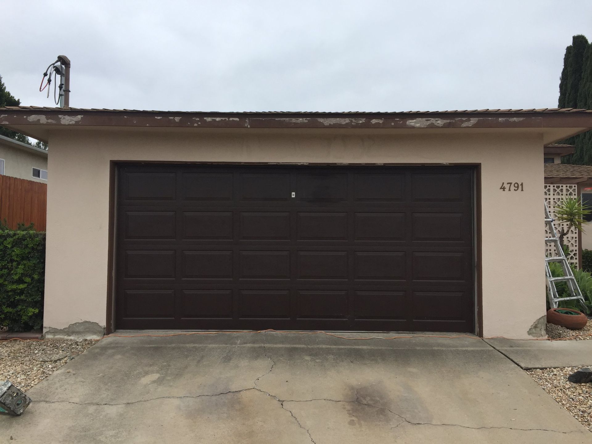 A brown garage door with the number 4191 on it