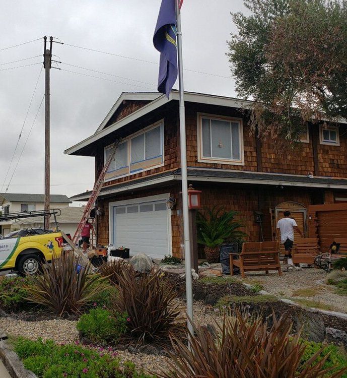 A house with a flag on the pole in front of it
