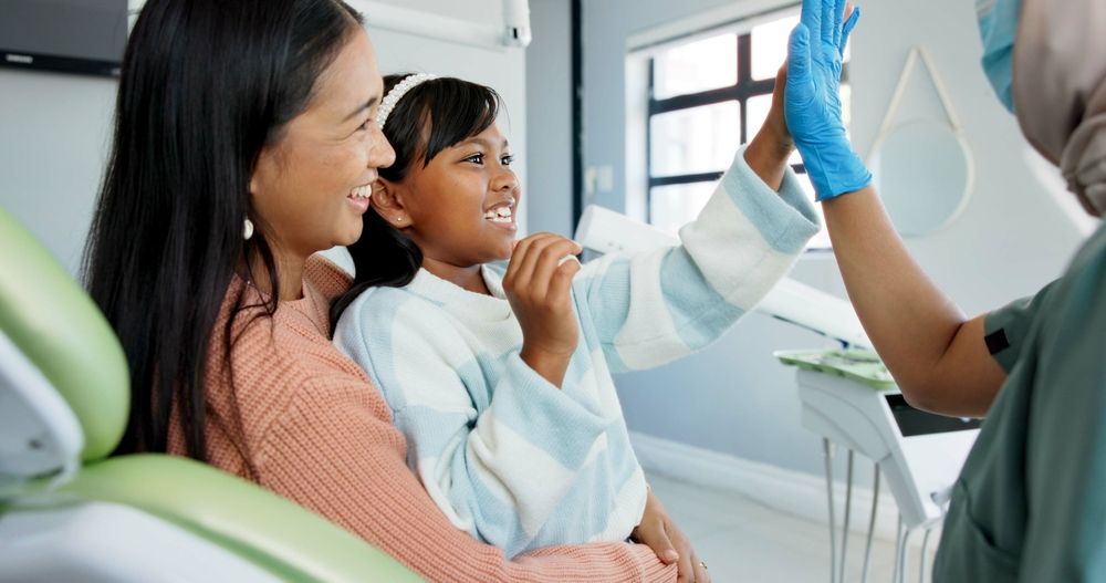 Parent and child visiting a dental professional for family dental care
