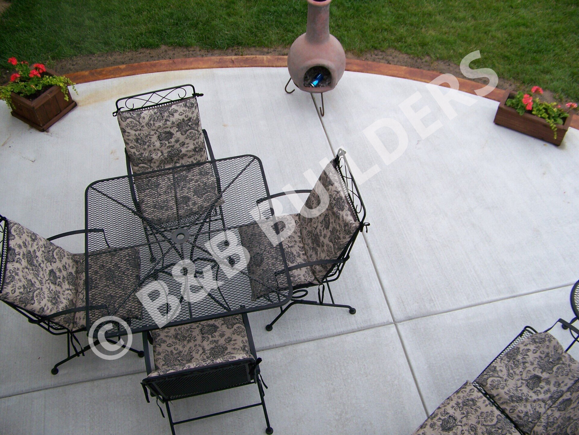 A  circular concrete patio with red border