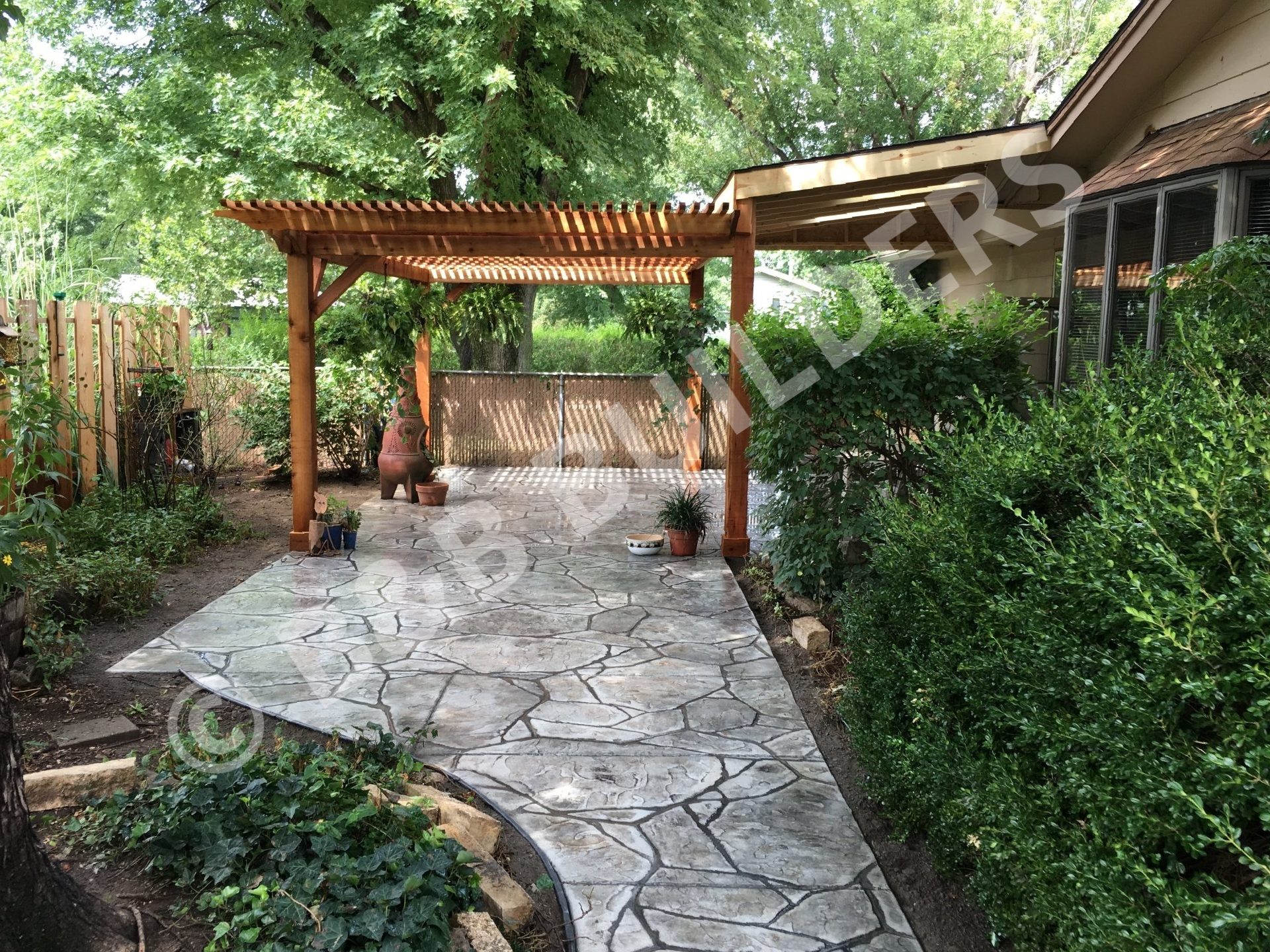 Stamped concrete patio with wooden pergola