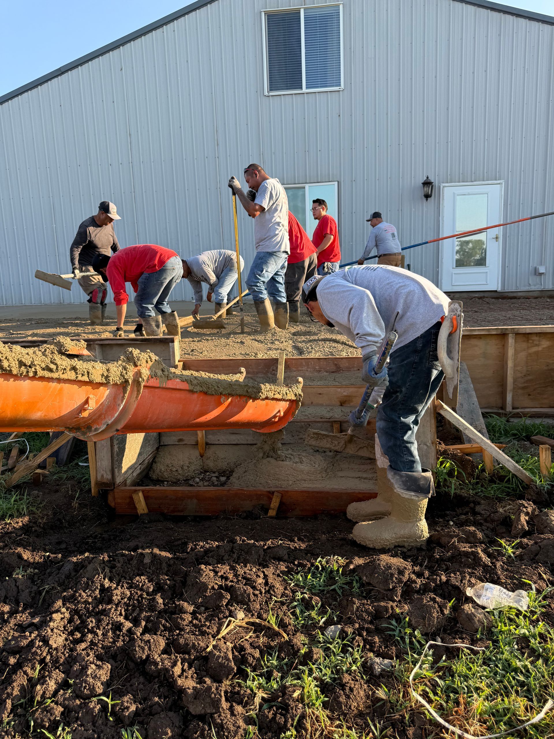 B & B Builders crew placing and finishing a concrete driveway pour on a Wichita, Kansas jobsite.