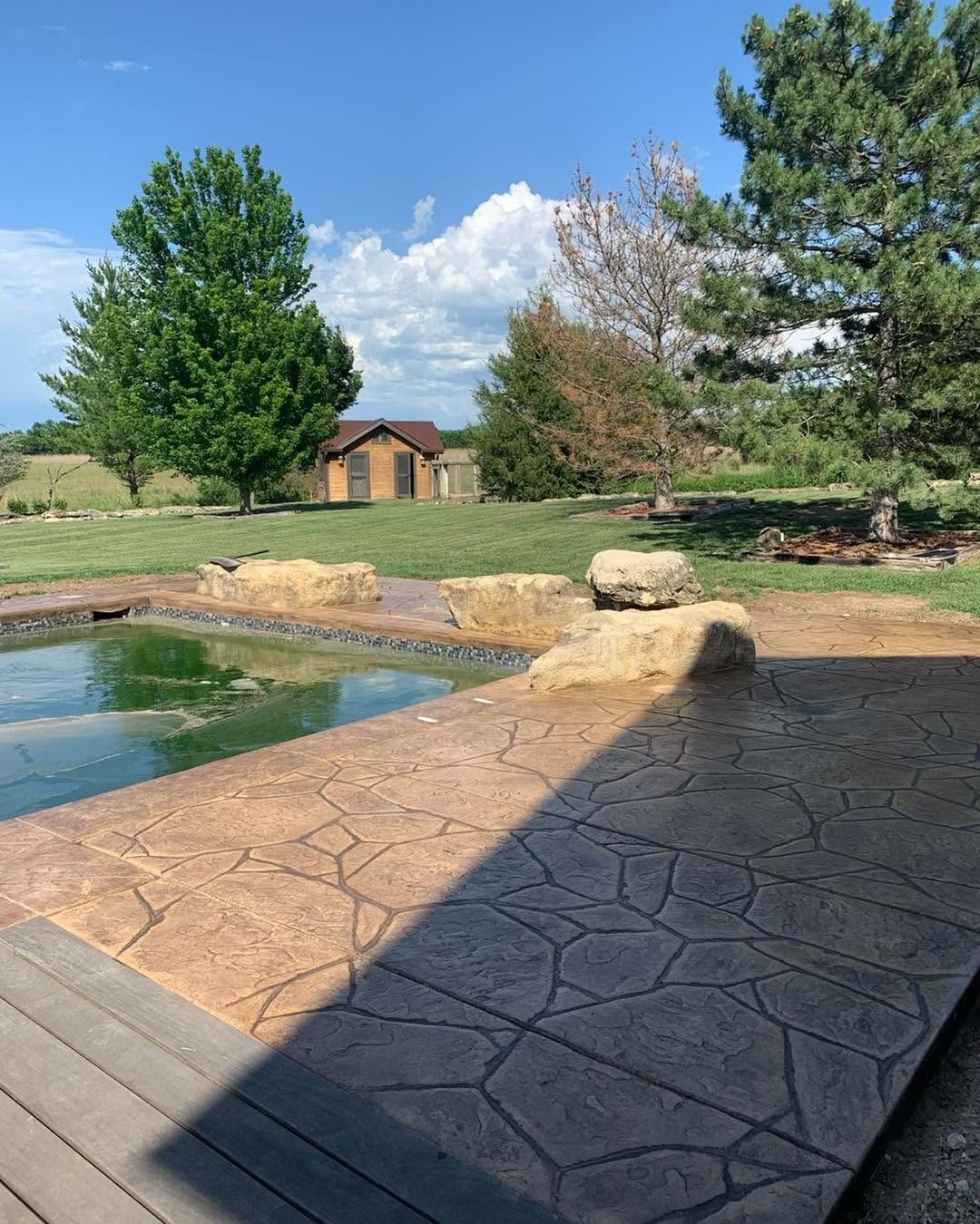 Backyard view from a covered outdoor living structure built by B&B Builders in Kansas