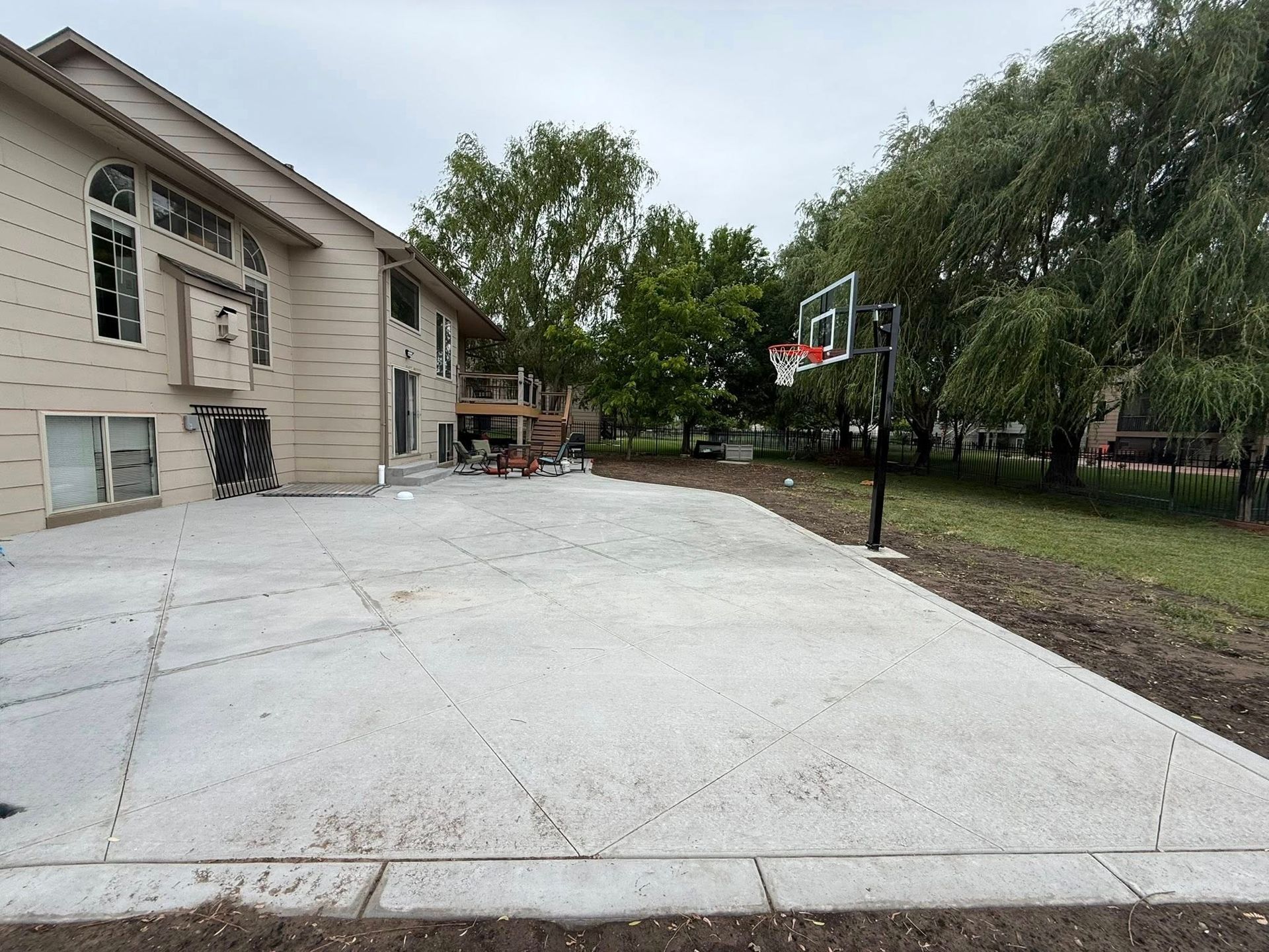 Freshly poured concrete driveway slab alongside a Wichita home