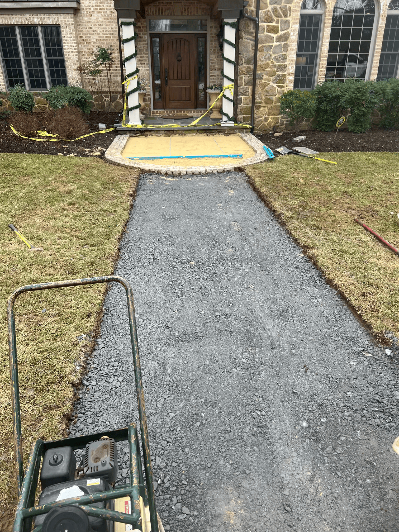 A driveway is being built in front of a house.