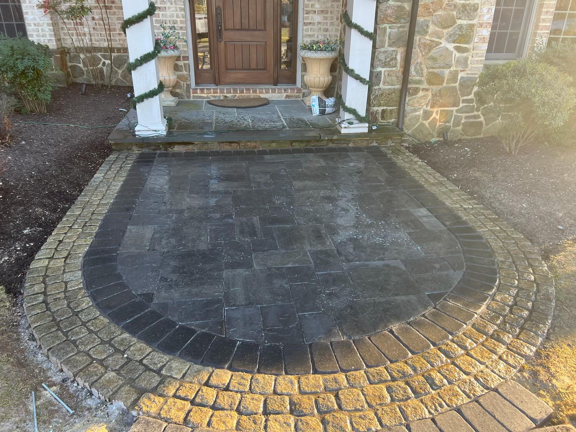 A brick walkway leading to the front door of a house