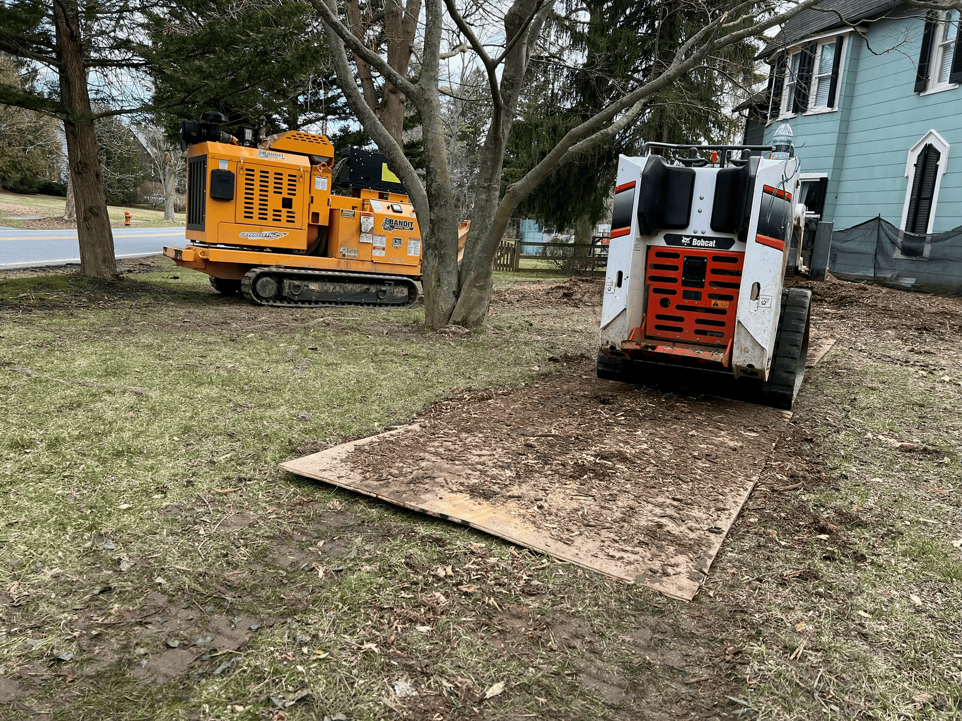A bulldozer is loading wood chips into a bucket.