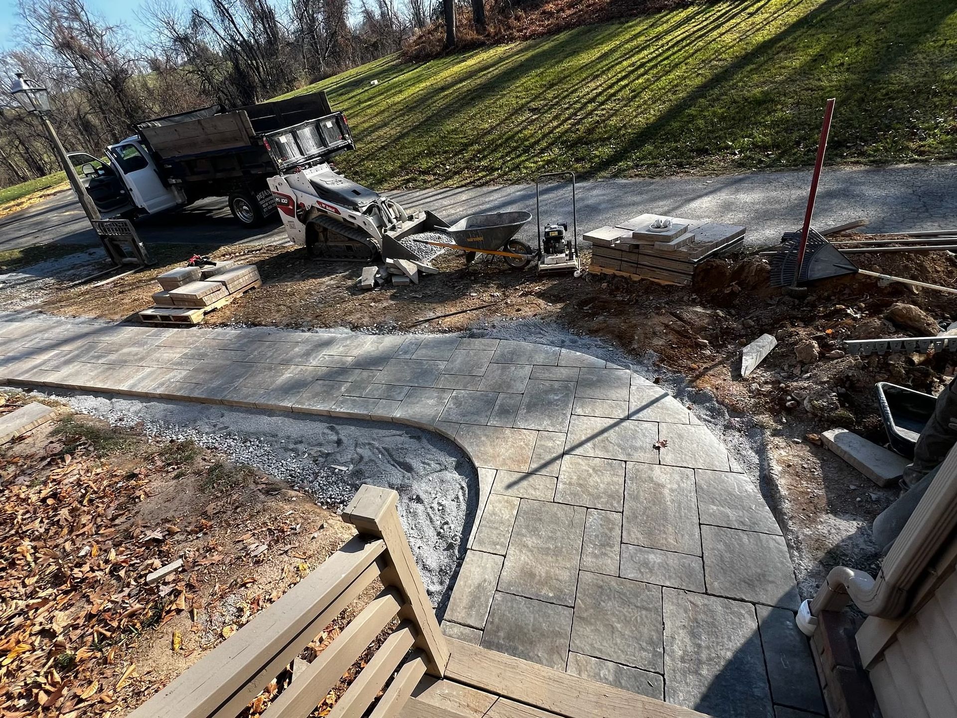A concrete walkway is being built in the backyard of a house.